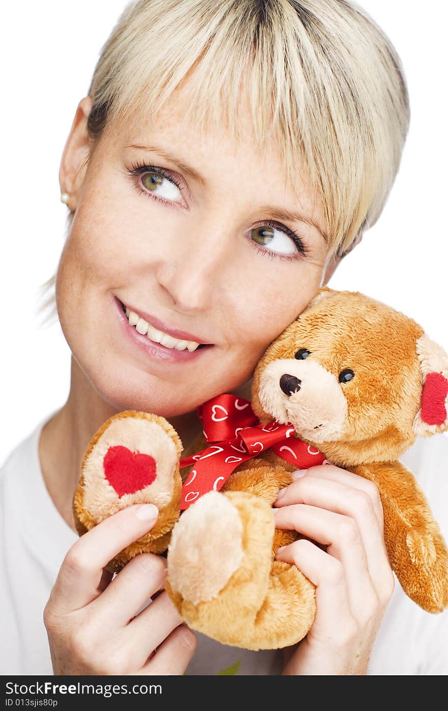 Young blond girl with teddy bear close up