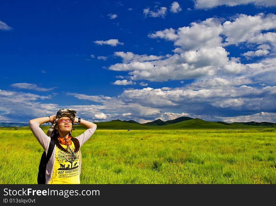 Happy girl on meadow,sky