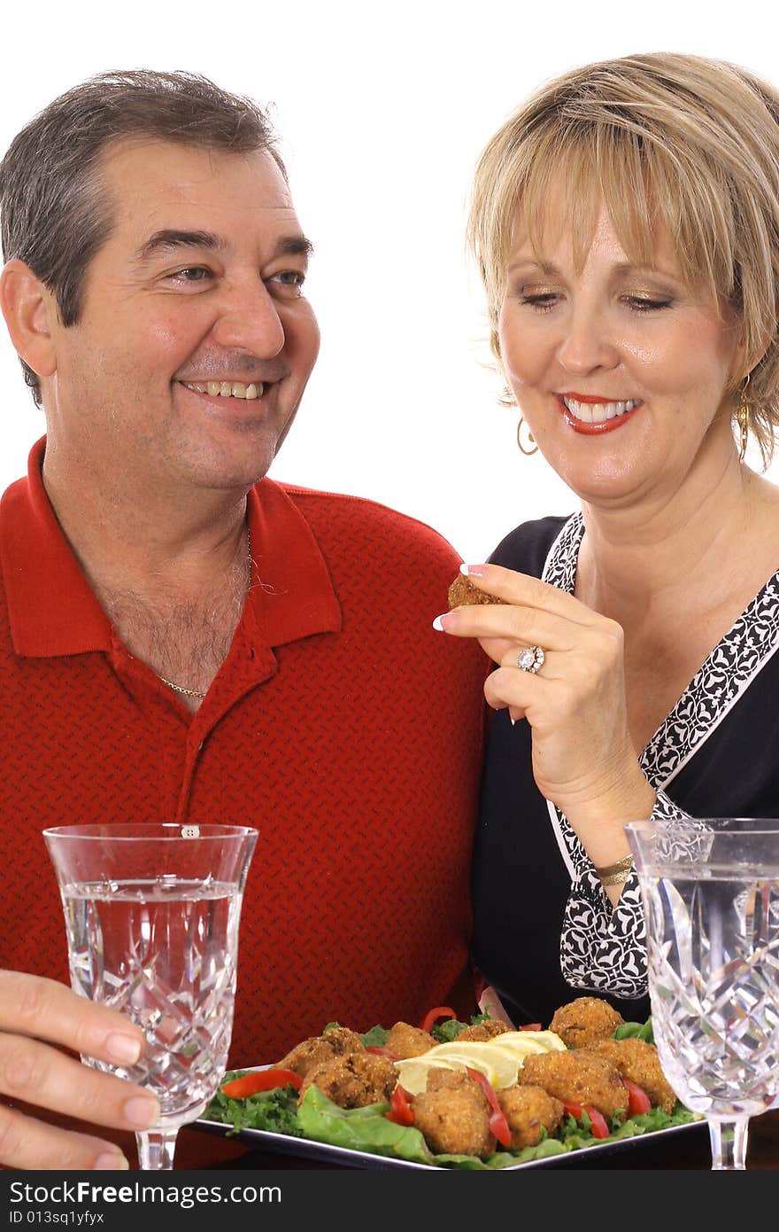 Couple having appetizers isolated on white