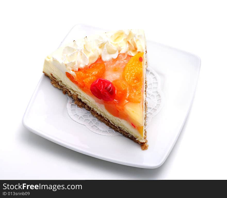 Fruit Cheese Cake on a Plate Isolated on White Background. Fruit Cheese Cake on a Plate Isolated on White Background