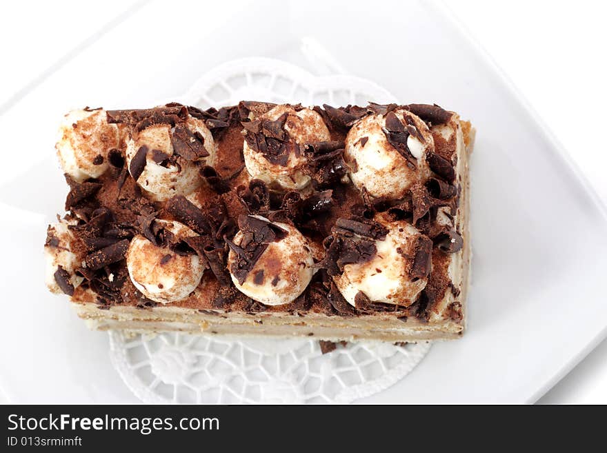 Chocolate Cake on a Plate Isolated on White Background. Chocolate Cake on a Plate Isolated on White Background