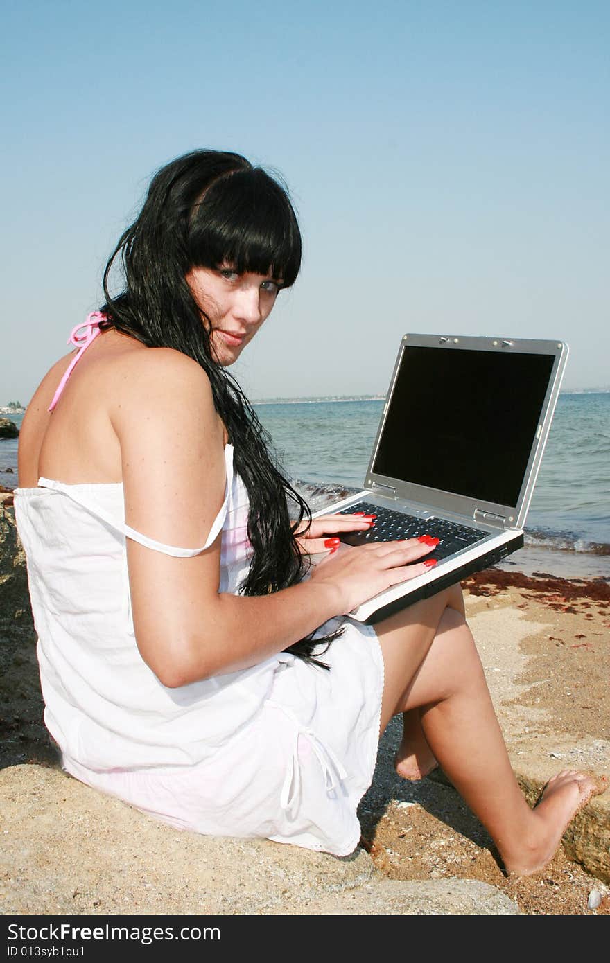 Girl on a beach with a notebook