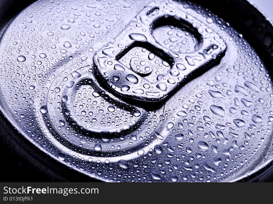 Close up of a metal pop top from a beverage can with drops. Close up of a metal pop top from a beverage can with drops