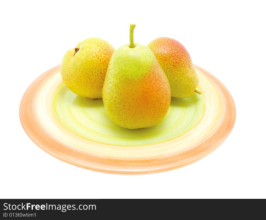 Three green pears on a  plate over white.