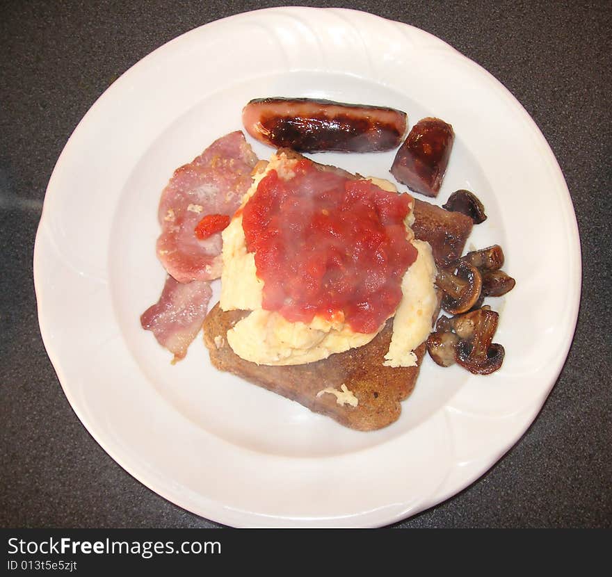 Cooked breakfast on one slice of wholemeal bread still steaming hot