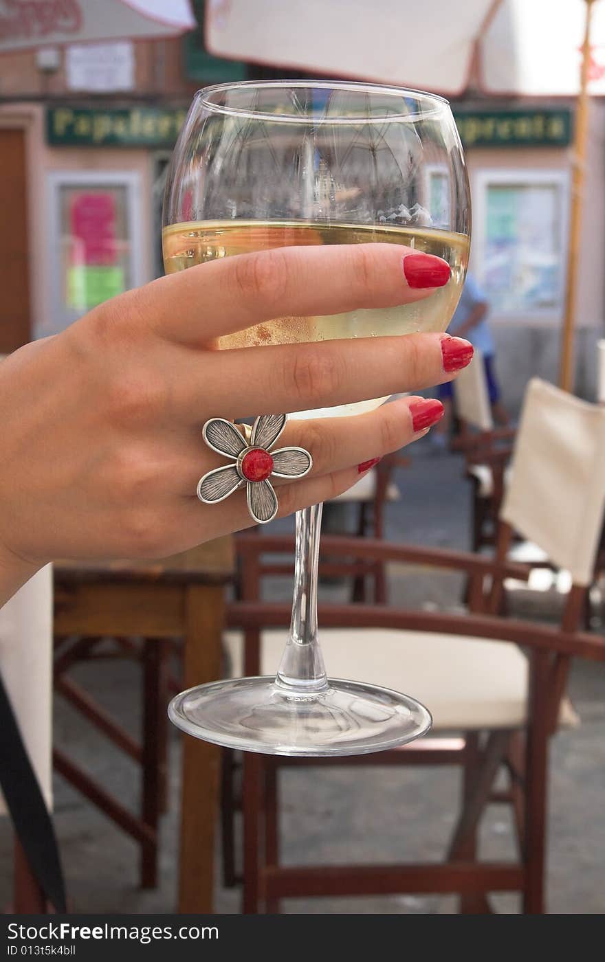 White wine glass in a hand. White wine glass in a hand