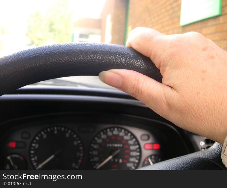 Hand on the steering wheel of a car. Hand on the steering wheel of a car