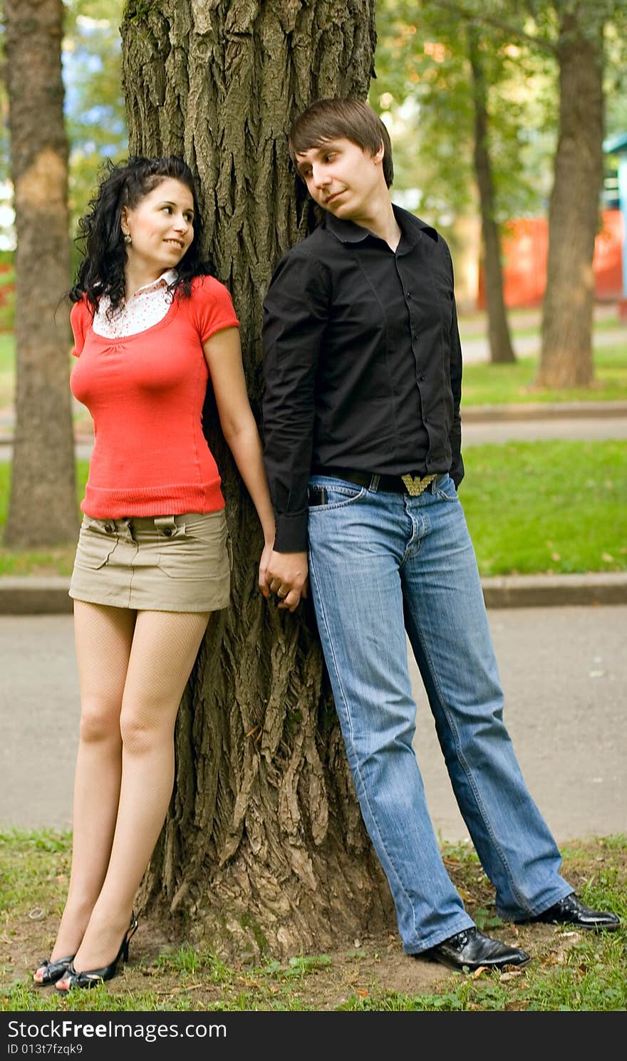 Happy young couple near the tree