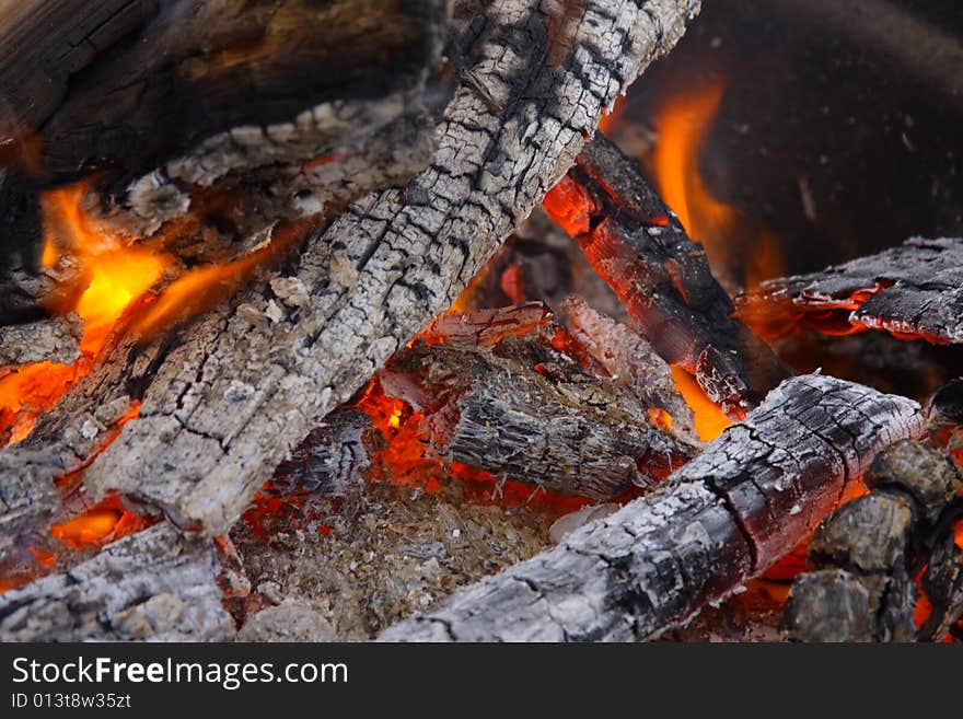 Campfire wood fire burning with charred coals. Campfire wood fire burning with charred coals.