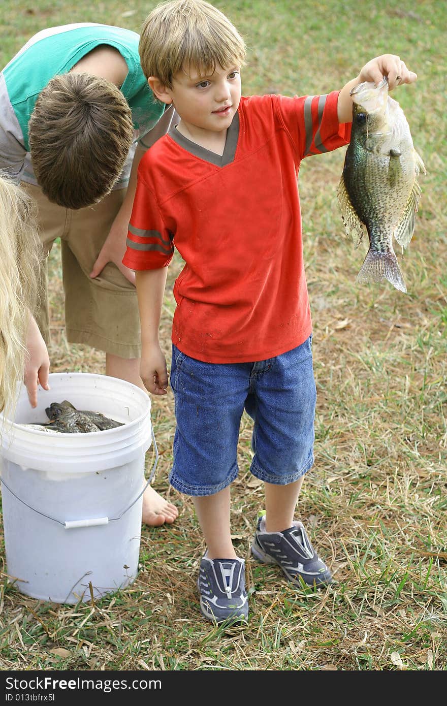 Young boy showing off his catch