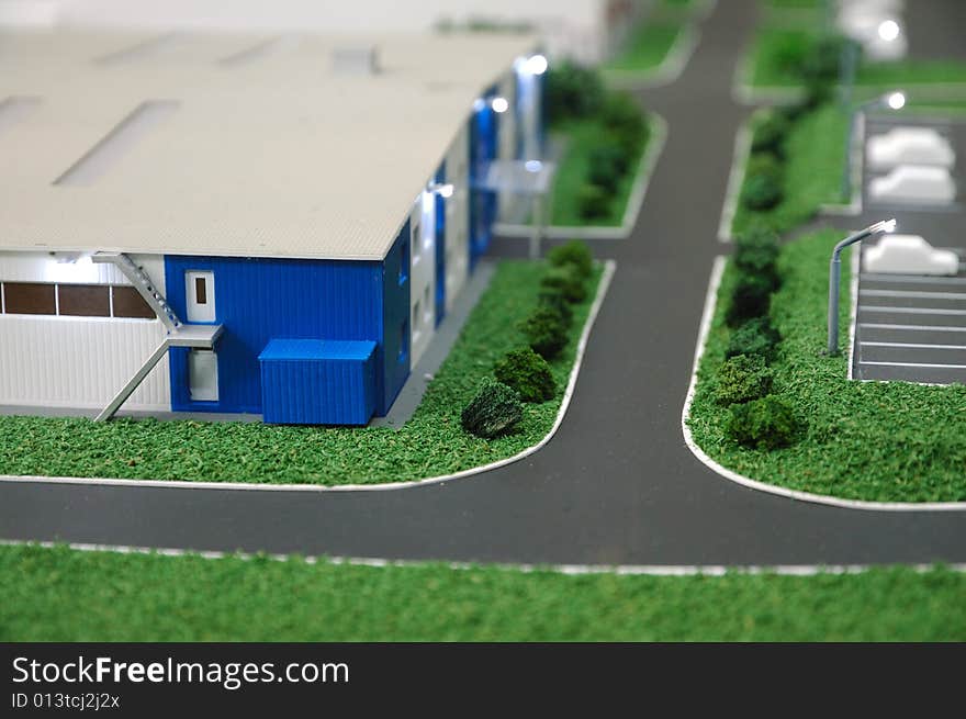 Prototype of modern warehouse with parking and cars