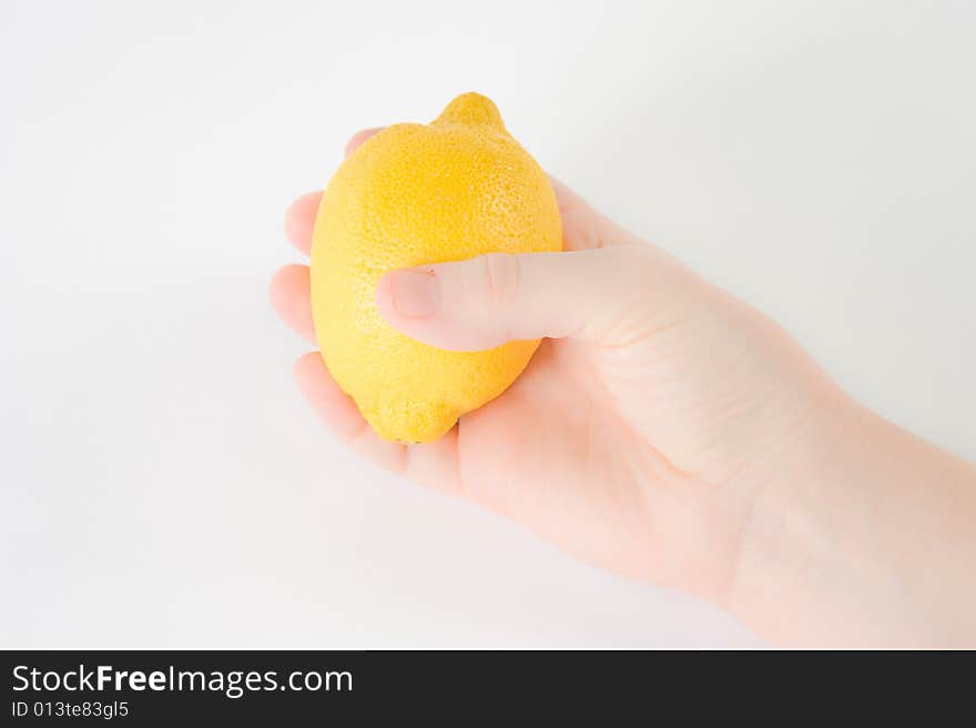 Hand holding a Lemon on White