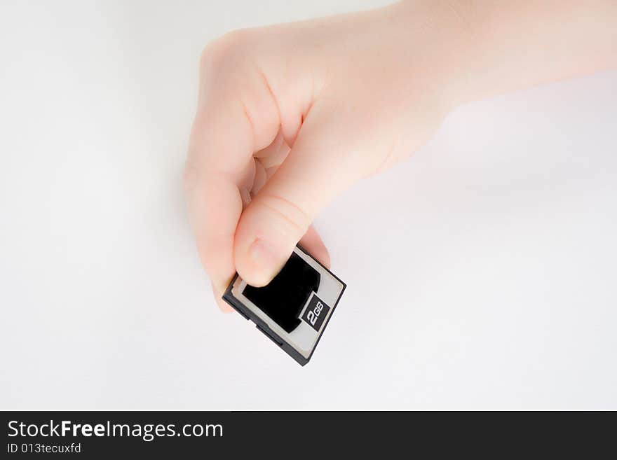 Hand holding a memory card against a white background. Hand holding a memory card against a white background