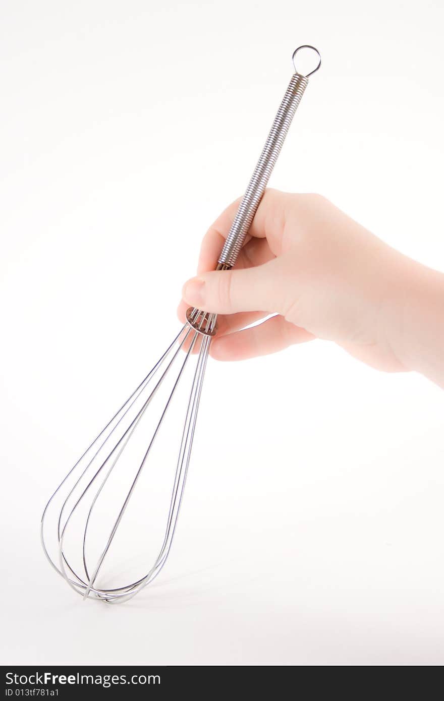 Hand holding a whisk