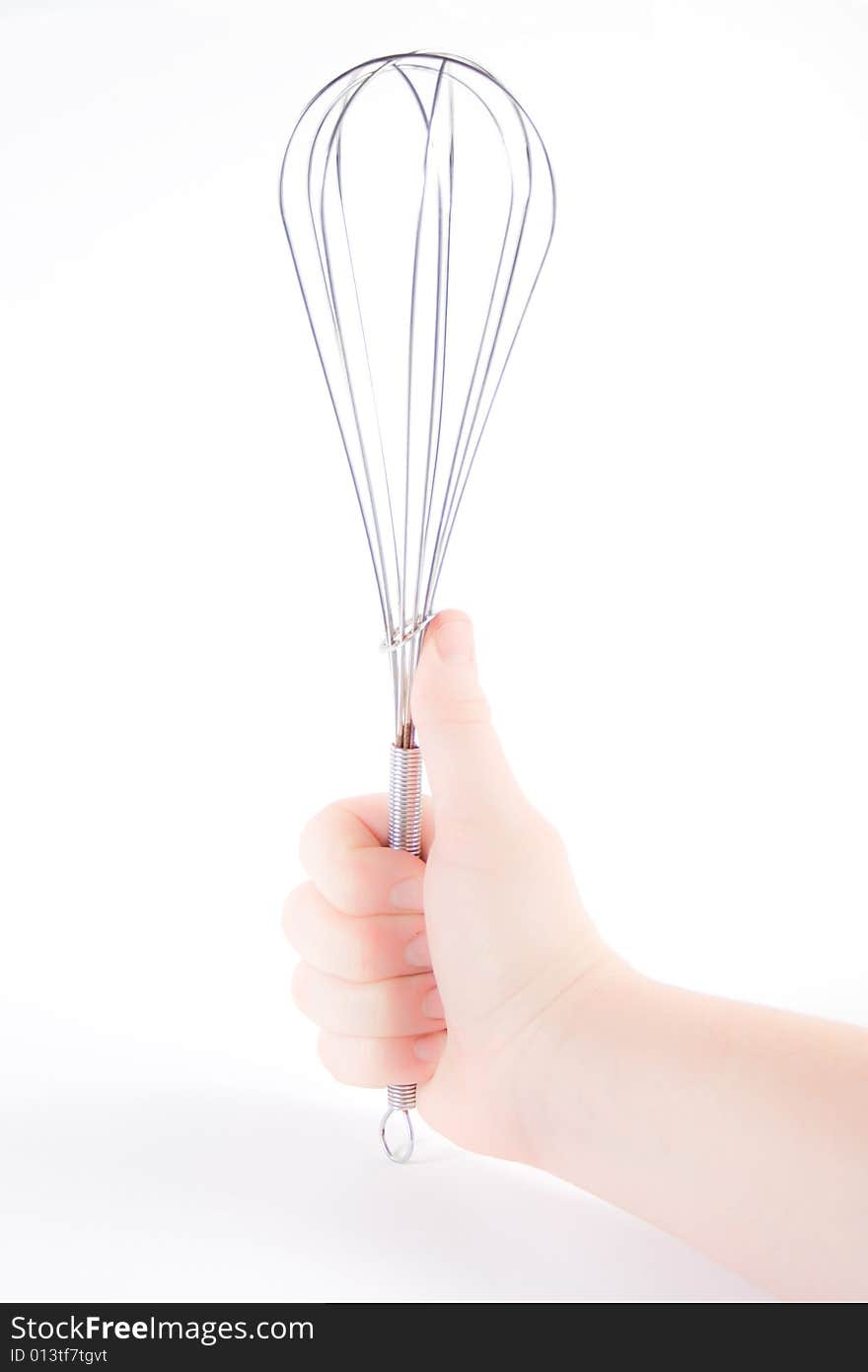 Hand holding a whisk