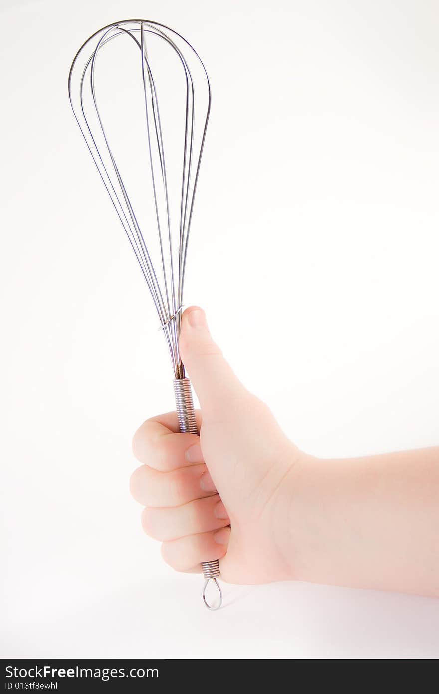 Hand holding a whisk