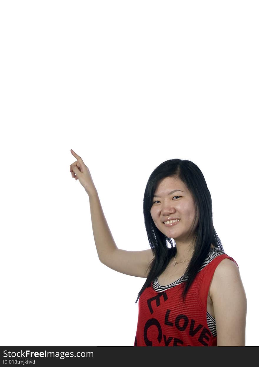 Young girl pointing upwards on white background