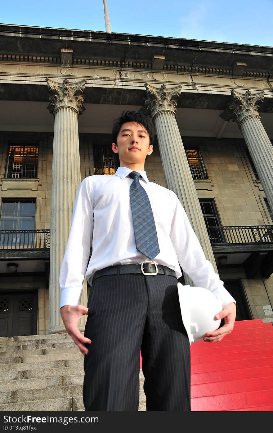 Picture of Asian Guy. Suitable for Job Search, Career Guidance context. He is pictured with an Engineer's hard hat. Picture of Asian Guy. Suitable for Job Search, Career Guidance context. He is pictured with an Engineer's hard hat