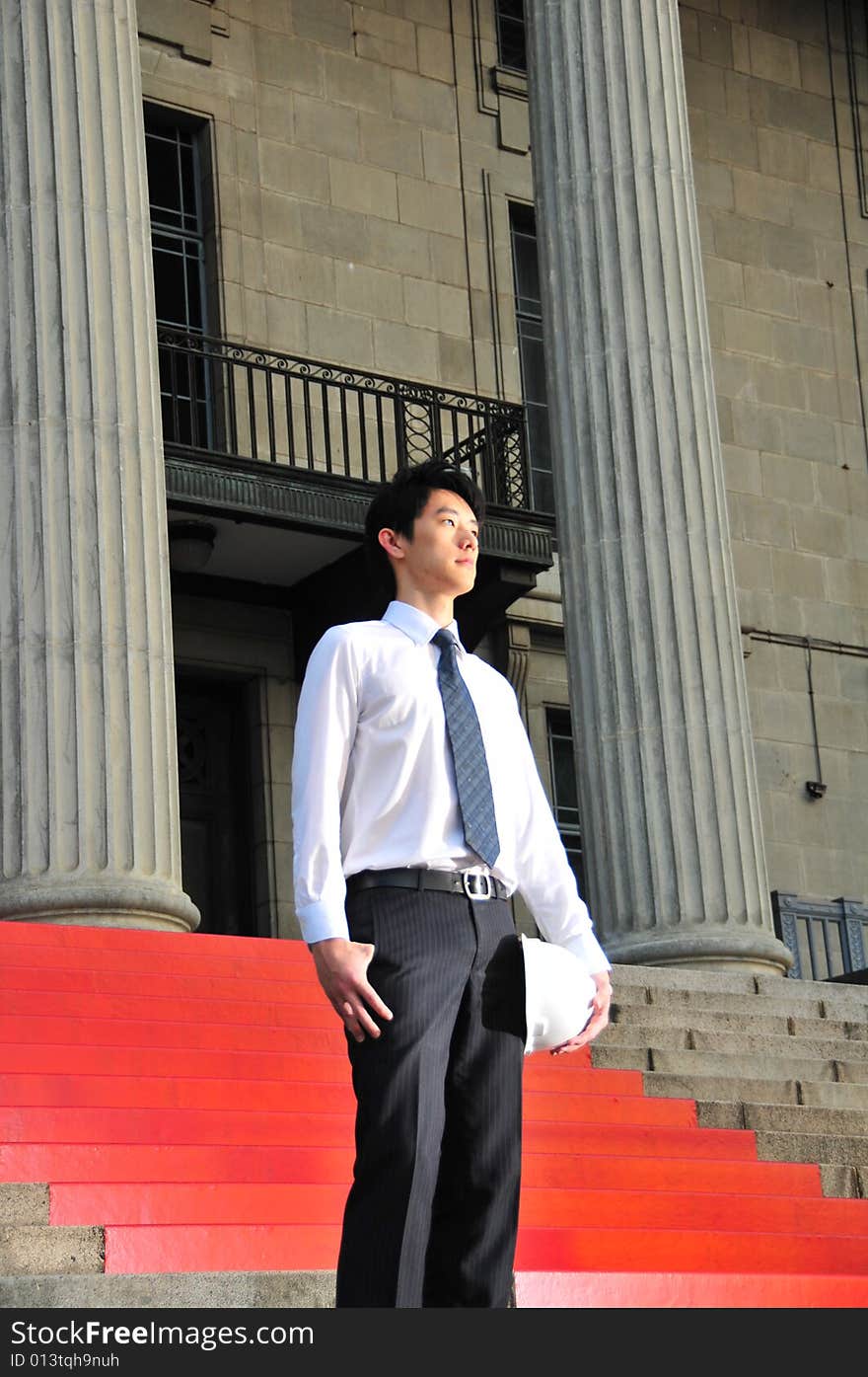 Picture of Asian Guy. Suitable for Job Search, Career Guidance context. He is pictured with an Engineer's hard hat. Picture of Asian Guy. Suitable for Job Search, Career Guidance context. He is pictured with an Engineer's hard hat