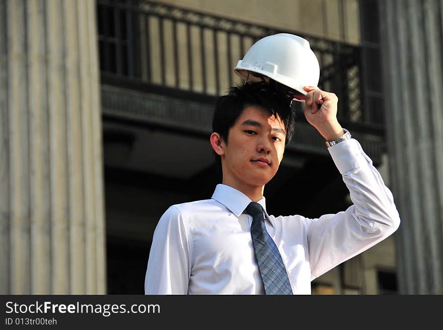 Picture of Asian Guy. Suitable for Job Search, Career Guidance context. He is pictured with an Engineer's hard hat. Picture of Asian Guy. Suitable for Job Search, Career Guidance context. He is pictured with an Engineer's hard hat