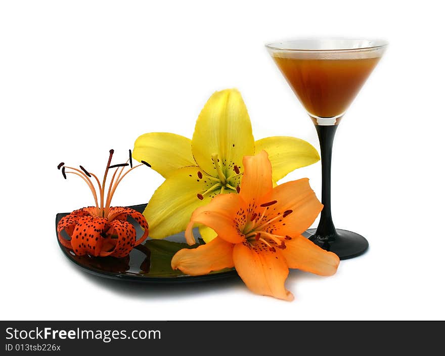 Transparent wineglass with peach juice and flowers