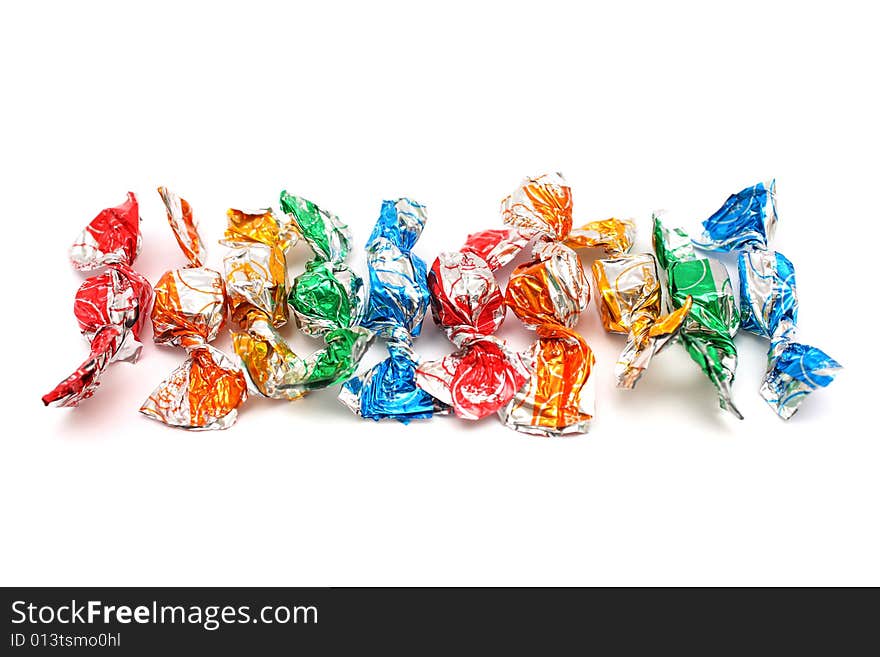 A pile of colorful candies isolated on white background. A pile of colorful candies isolated on white background.