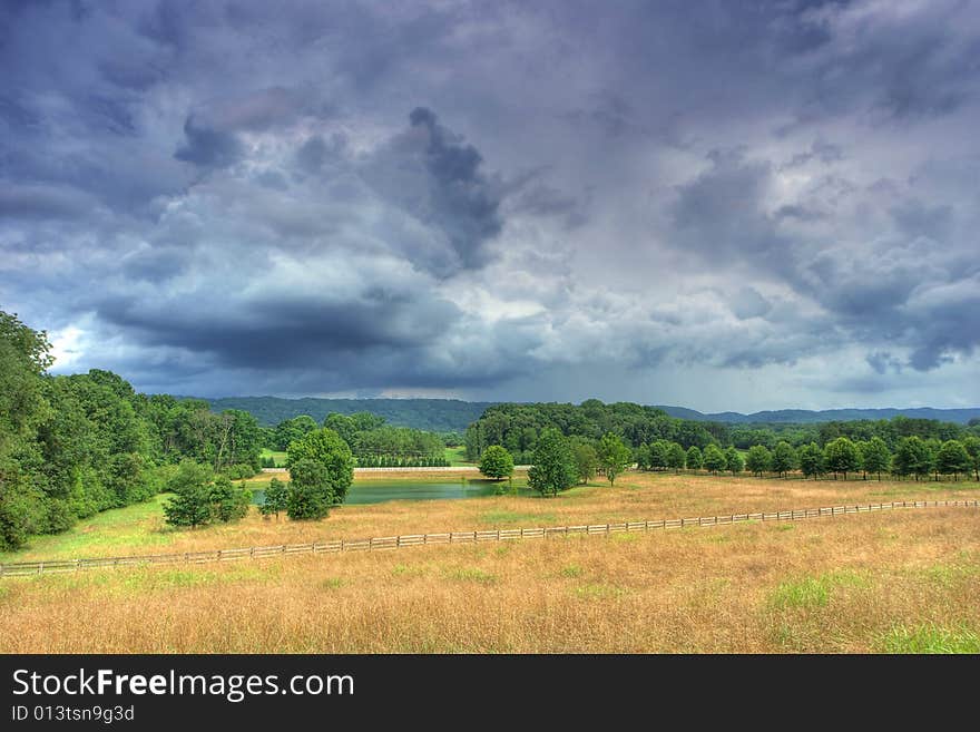 A summer field under a stormy sky. A summer field under a stormy sky.