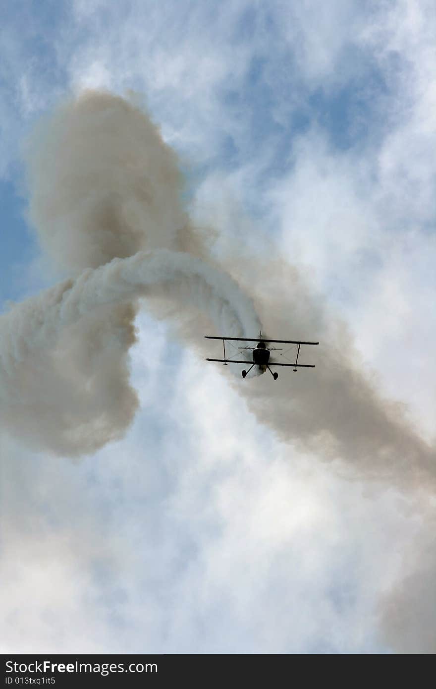 Acrobatic plane in action during airshow maneuvers. Acrobatic plane in action during airshow maneuvers