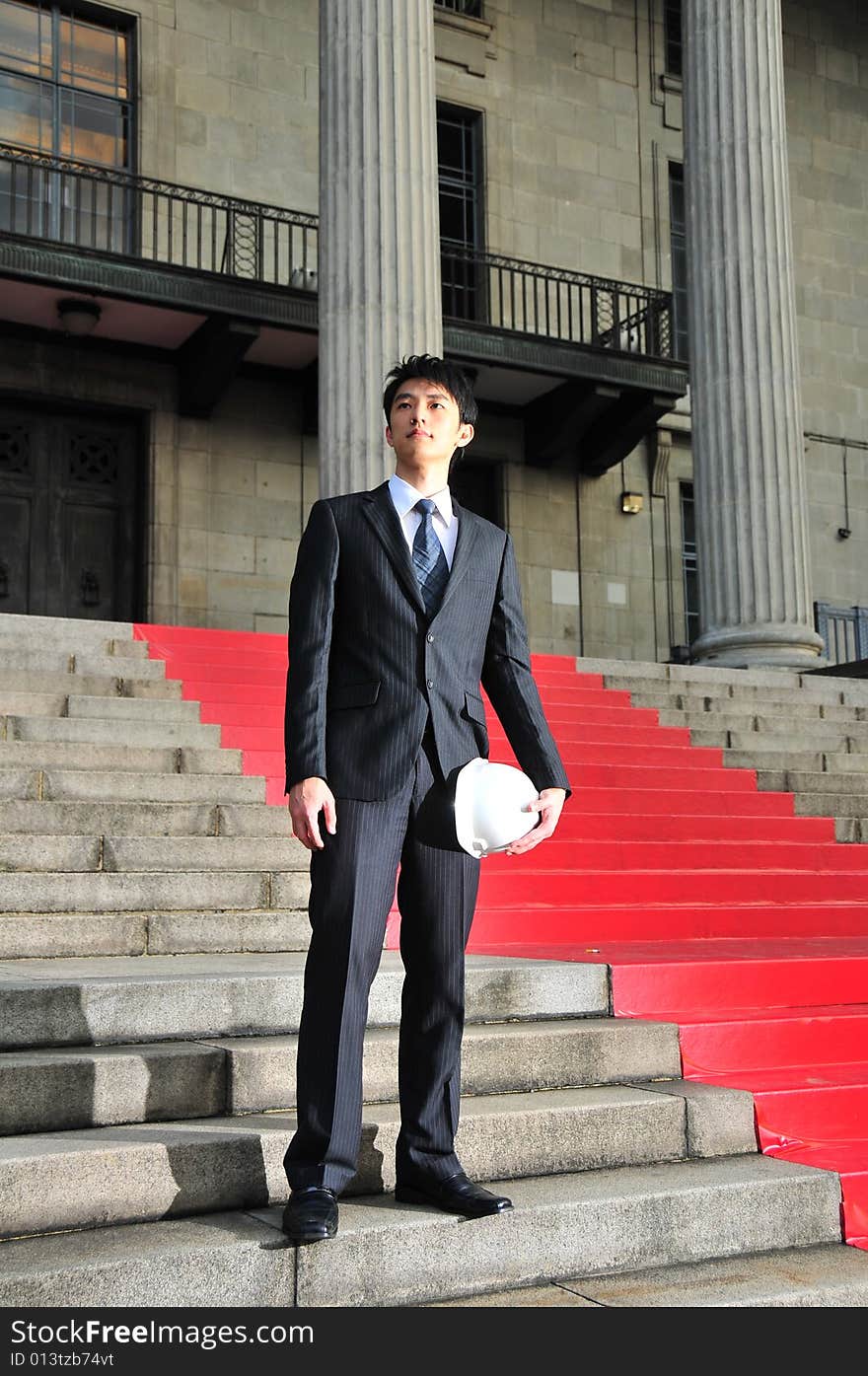 Picture of Asian Guy. Suitable for Job Search, Career Guidance context. He is pictured with an Engineer's hard hat. Picture of Asian Guy. Suitable for Job Search, Career Guidance context. He is pictured with an Engineer's hard hat