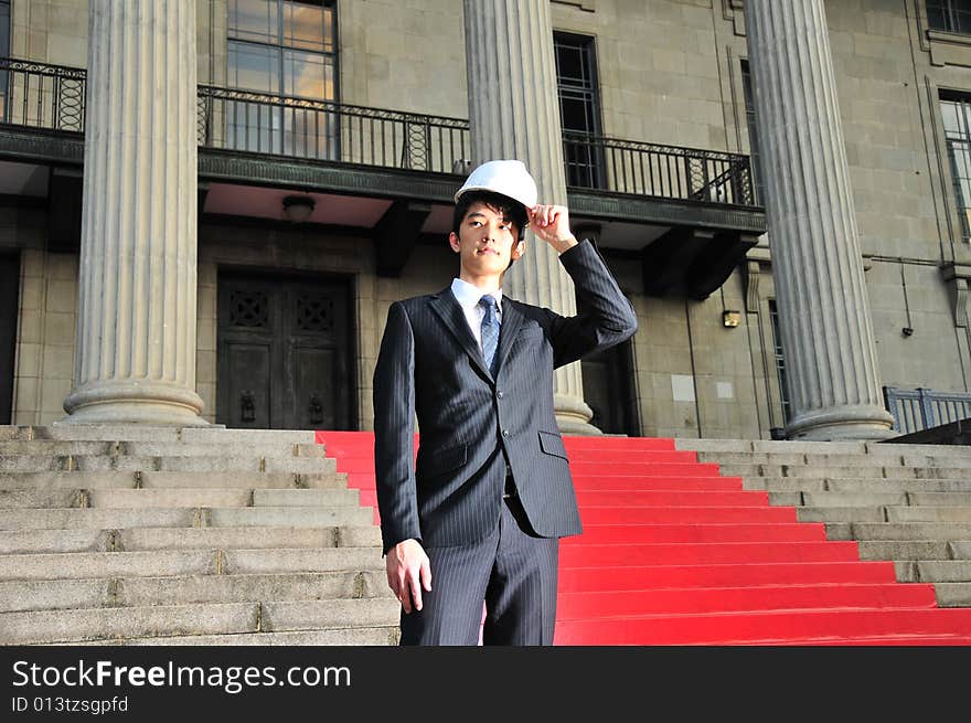 Picture of Asian Guy. Suitable for Job Search, Career Guidance context. He is pictured with an Engineer's hard hat. Picture of Asian Guy. Suitable for Job Search, Career Guidance context. He is pictured with an Engineer's hard hat