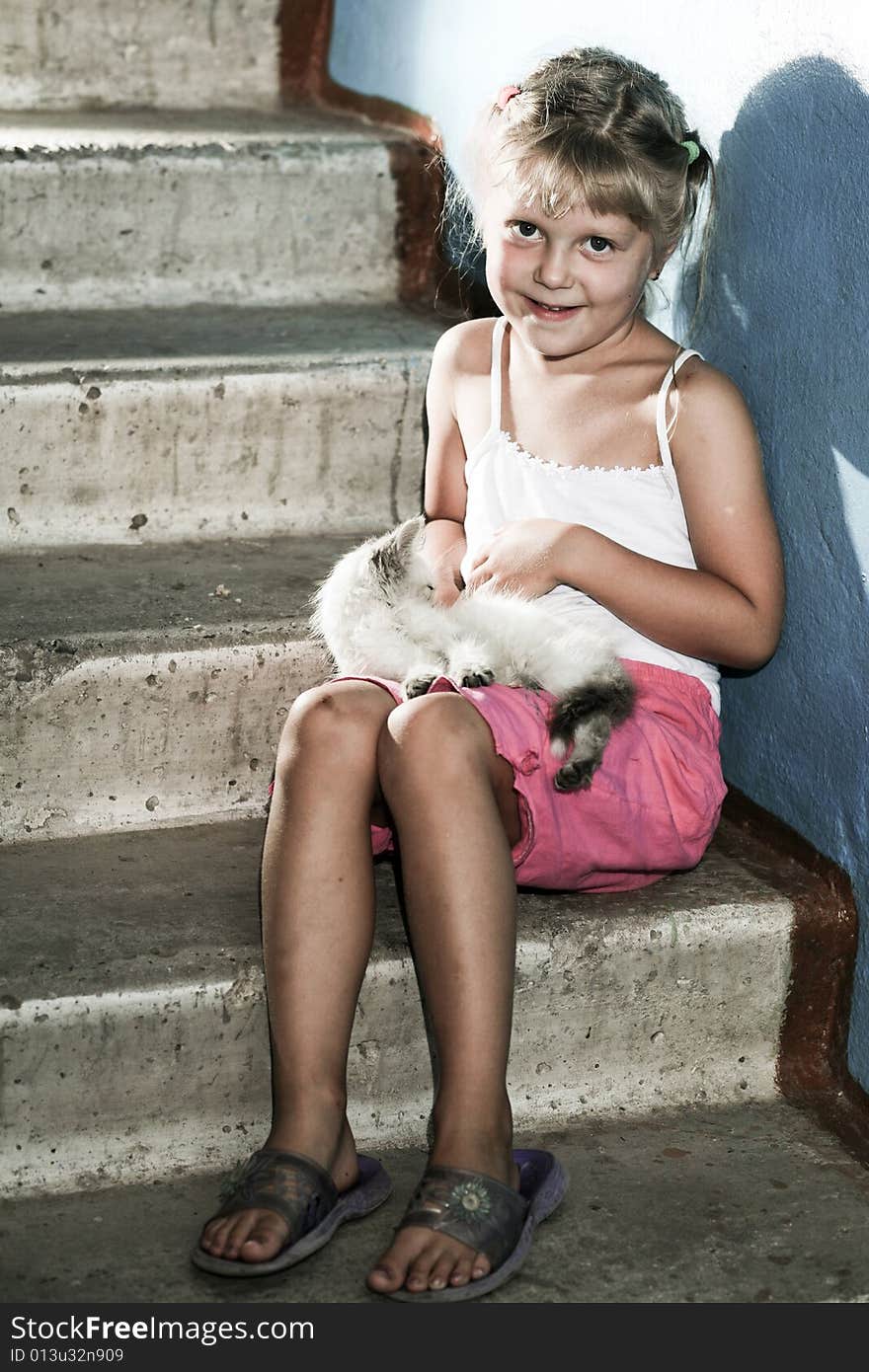 Friends. Smiling girl with a kitten in her arms. Friends. Smiling girl with a kitten in her arms