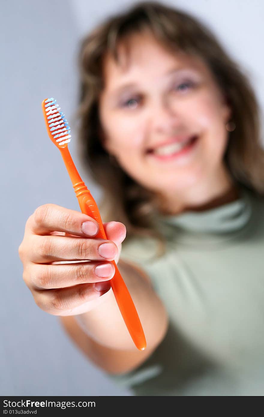 Portrait of young female holding yellow toothbrush. Portrait of young female holding yellow toothbrush.