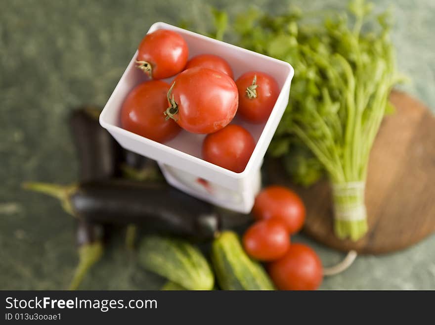 White kitchen scale and vegetable cucumber and tomato. White kitchen scale and vegetable cucumber and tomato