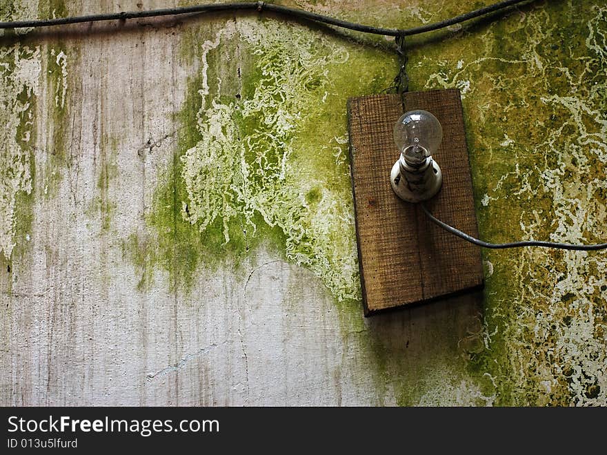 Close up of an old lamp on a grungy wall. Close up of an old lamp on a grungy wall