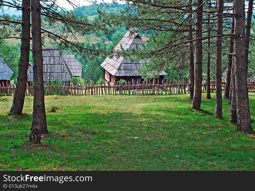 Ethnic Serbia, wooden house and fence over rural landscape