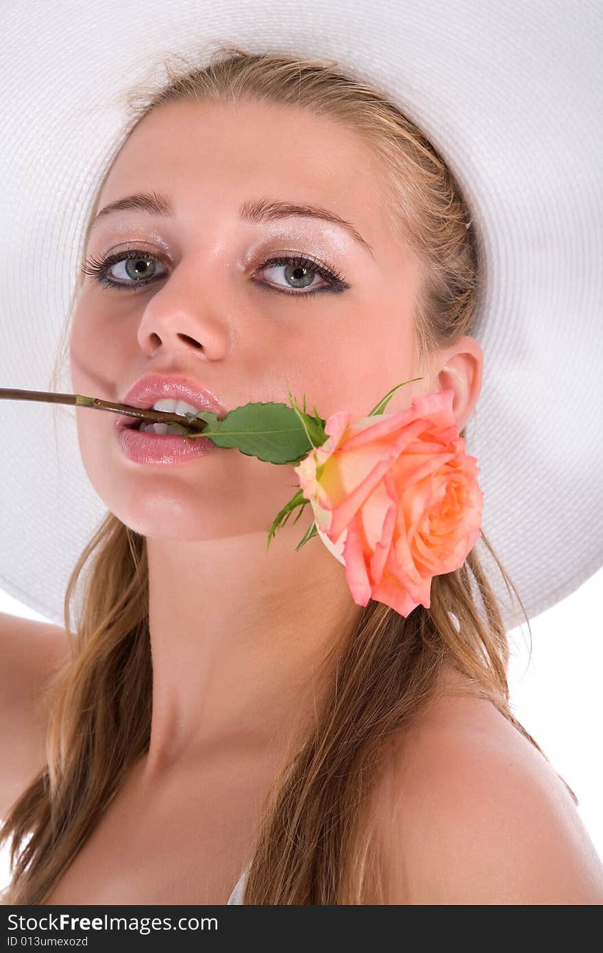 Portrait of the girl in a hat on the white