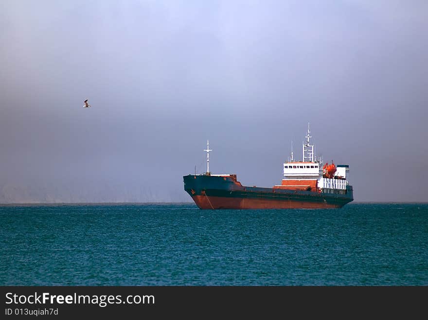 Nave on roadstead before storm on sea