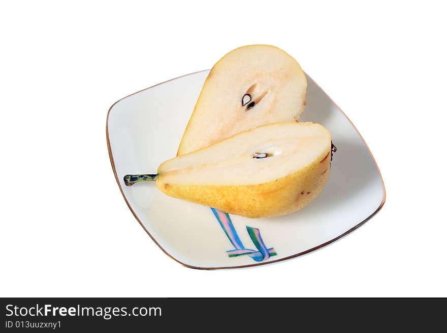 Slit pear lying on nice plate on white background