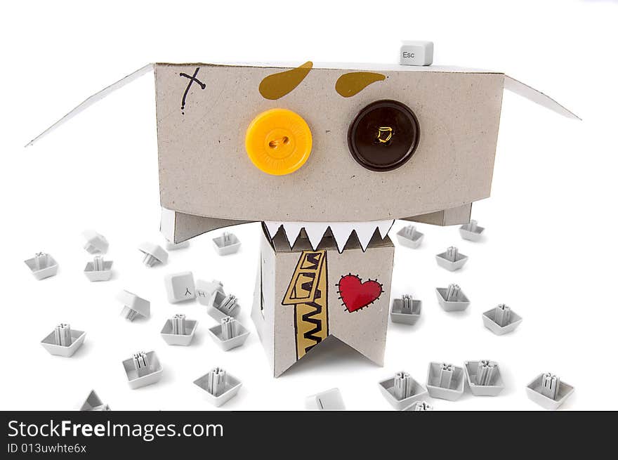 Toothy cardboard toy surrounded by keyboard buttons. Toothy cardboard toy surrounded by keyboard buttons