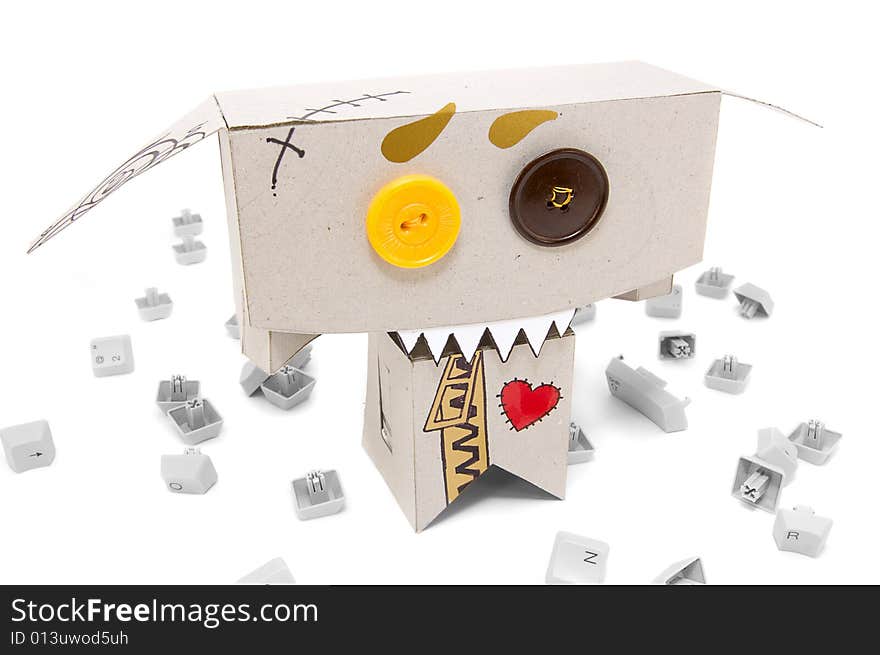 Toothy cardboard toy and broken keyboard buttons around. Toothy cardboard toy and broken keyboard buttons around