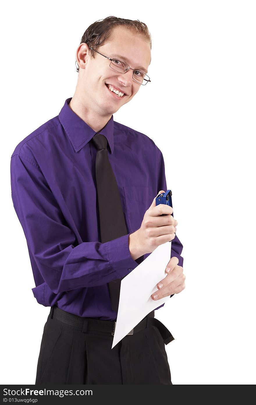 Young successful businessman wearing an office clothes stapling some paperwork together. Isolated on white background. Young successful businessman wearing an office clothes stapling some paperwork together. Isolated on white background