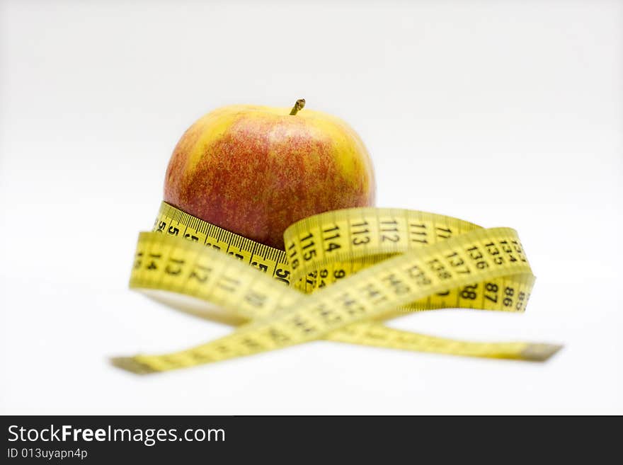 Red apple and tape measure