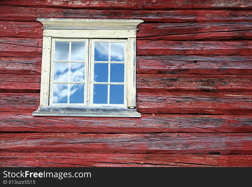 Window in wooden wall, country house.