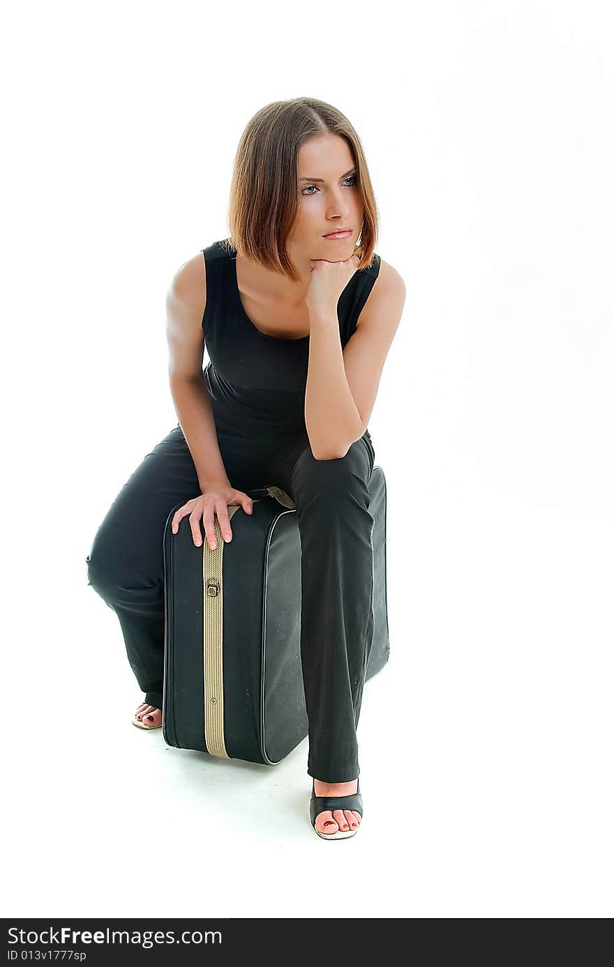 Young waiting woman sits on baggage