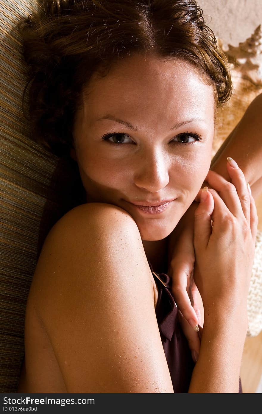 Beautiful girl relaxing on the beach (sunbathing)