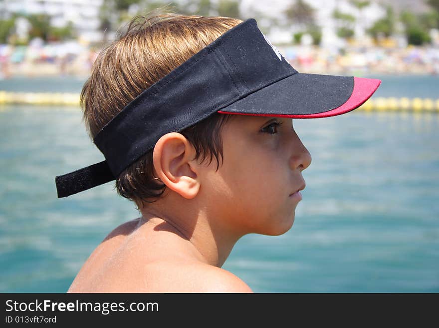 Child in the beach looking with a serious face. Child in the beach looking with a serious face