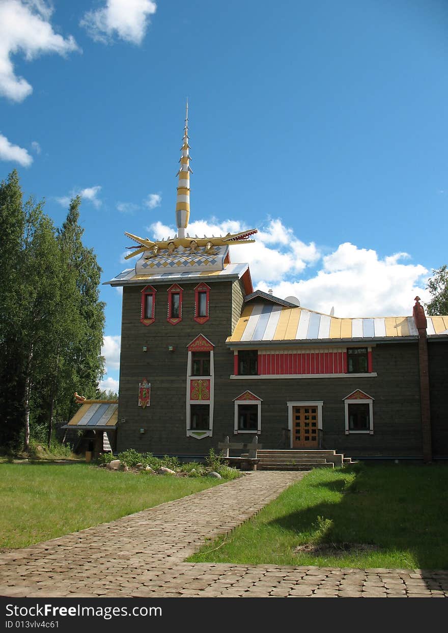 Russian style. Wooden blockhouse on the blue sky background. Russian style. Wooden blockhouse on the blue sky background.