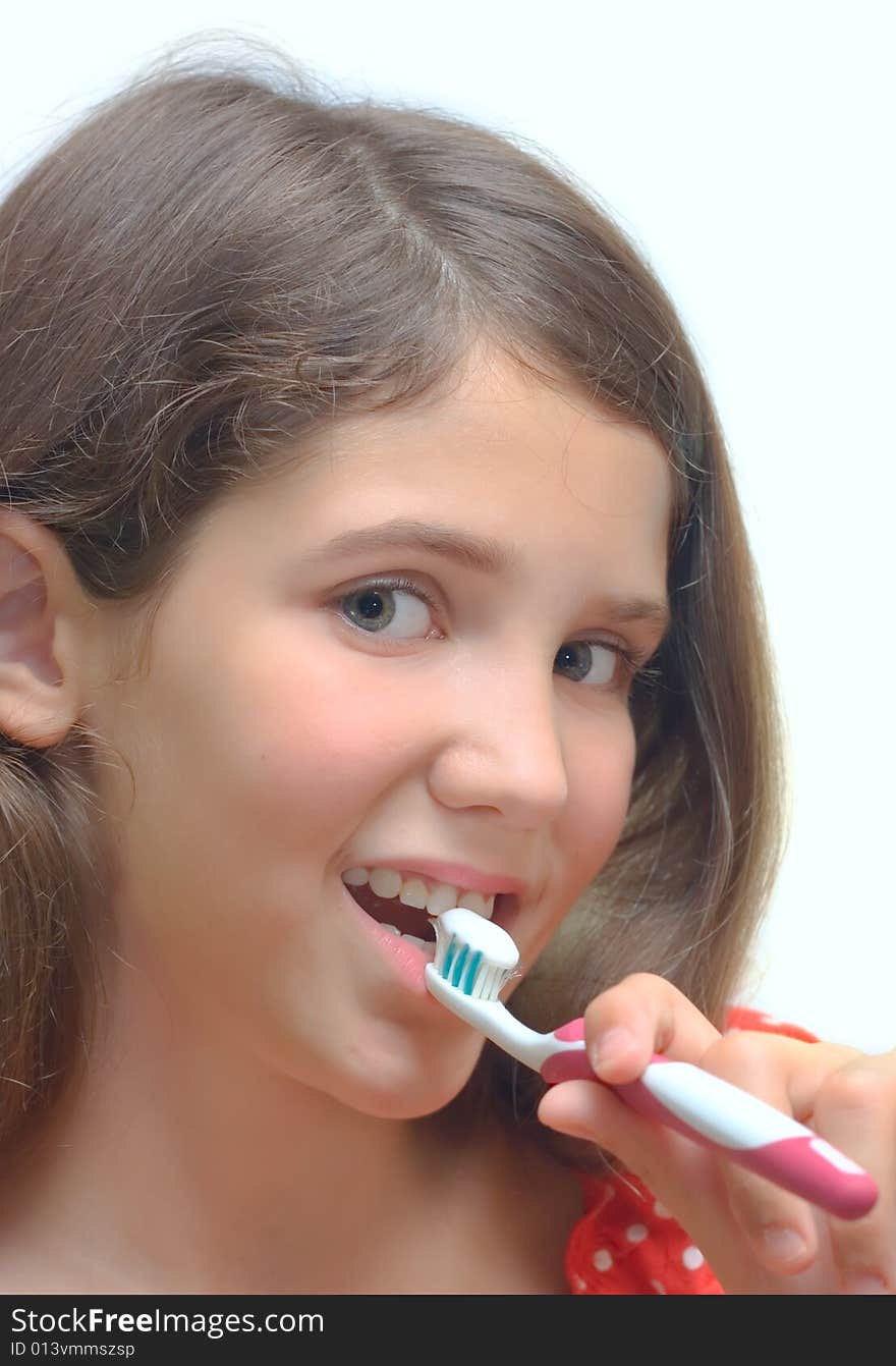 Girl with toothbrush isolated on white