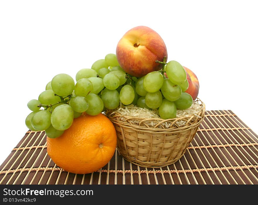 Peaches and orange in a yellow basket