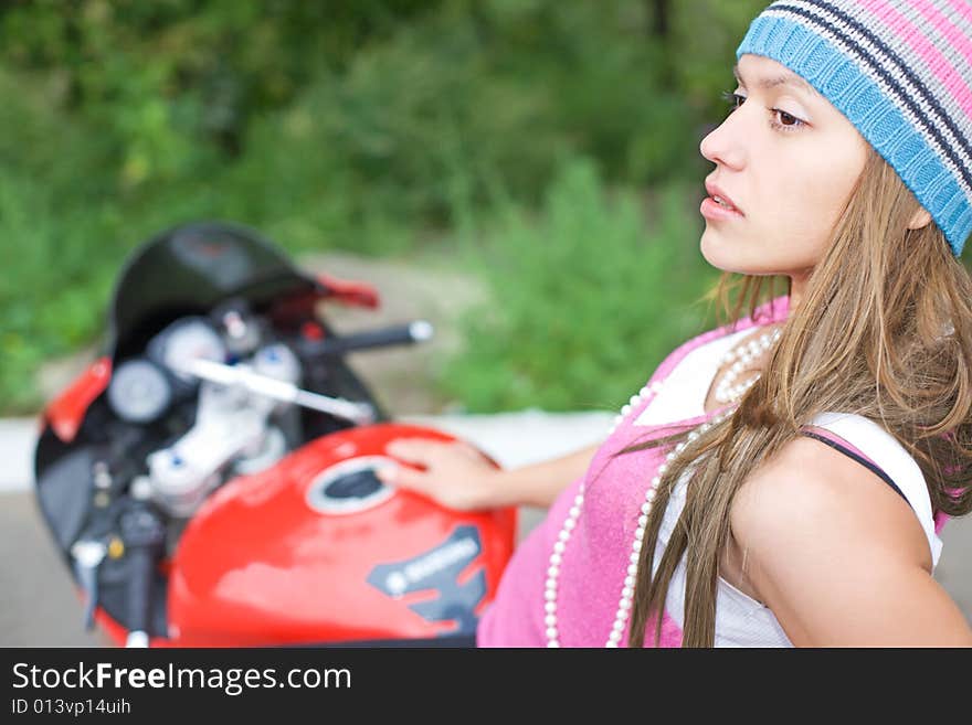 Closeup portrait of young woman on motorcycle. Closeup portrait of young woman on motorcycle